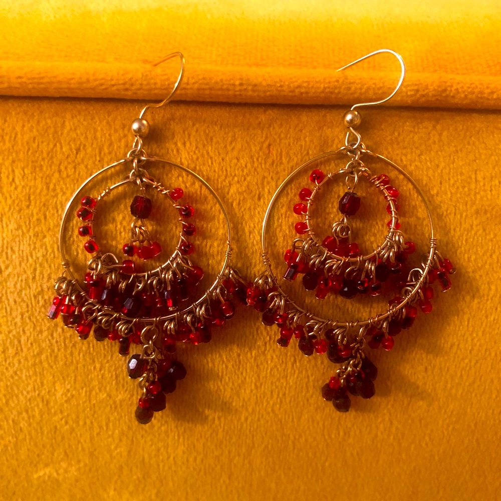 Gold wire and garnet beaded hanging hoop earrings. Medium sized hoops